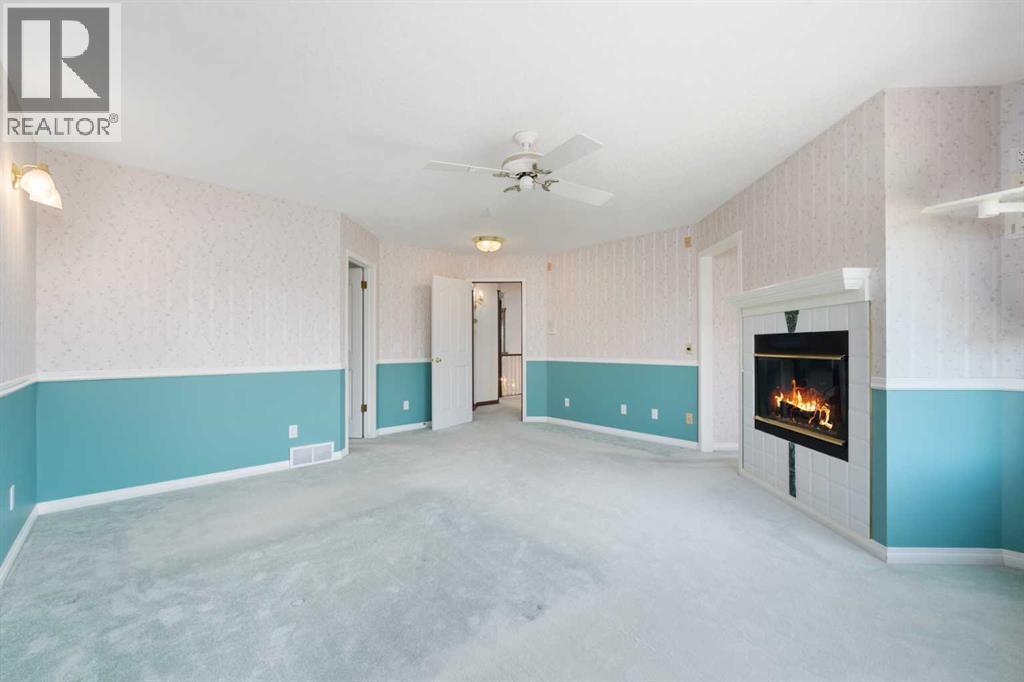 1600 Evergreen Hill Sw, Calgary, AB - Indoor Photo Showing Other Room With Fireplace