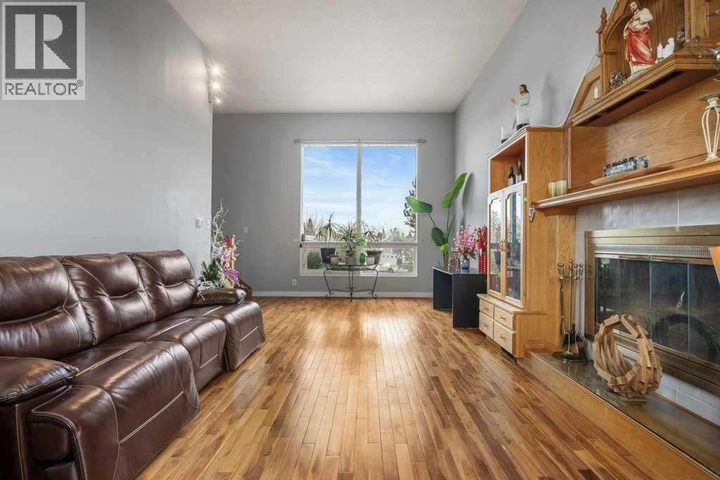 4704 Marbury Place Ne, Calgary, AB - Indoor Photo Showing Living Room With Fireplace
