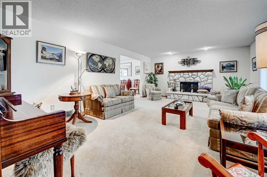 1111 Beverley Boulevard Sw, Calgary, AB - Indoor Photo Showing Living Room With Fireplace