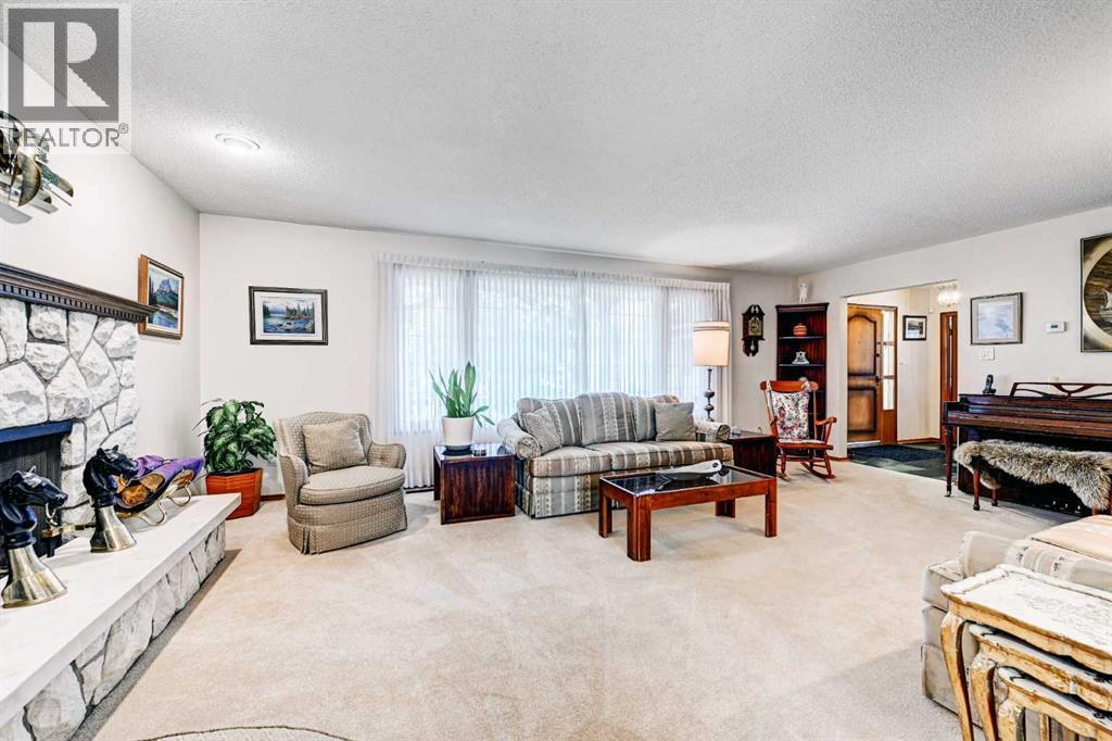 1111 Beverley Boulevard Sw, Calgary, AB - Indoor Photo Showing Living Room With Fireplace