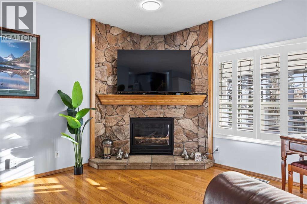 244 Oakmere Place, Chestermere, AB - Indoor Photo Showing Living Room With Fireplace