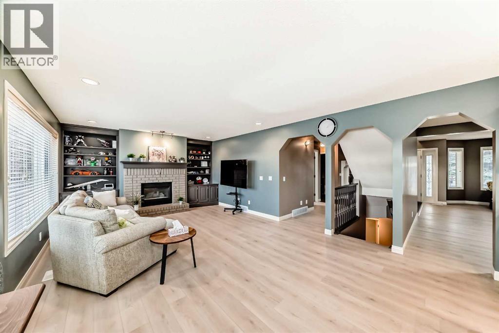 668 Scimitar Bay Nw, Calgary, AB - Indoor Photo Showing Living Room With Fireplace
