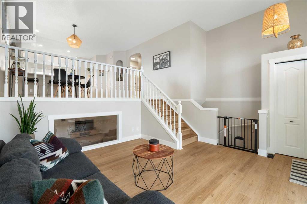Living Room - 111 Woodside Circle Nw, Airdrie, AB - Indoor With Fireplace