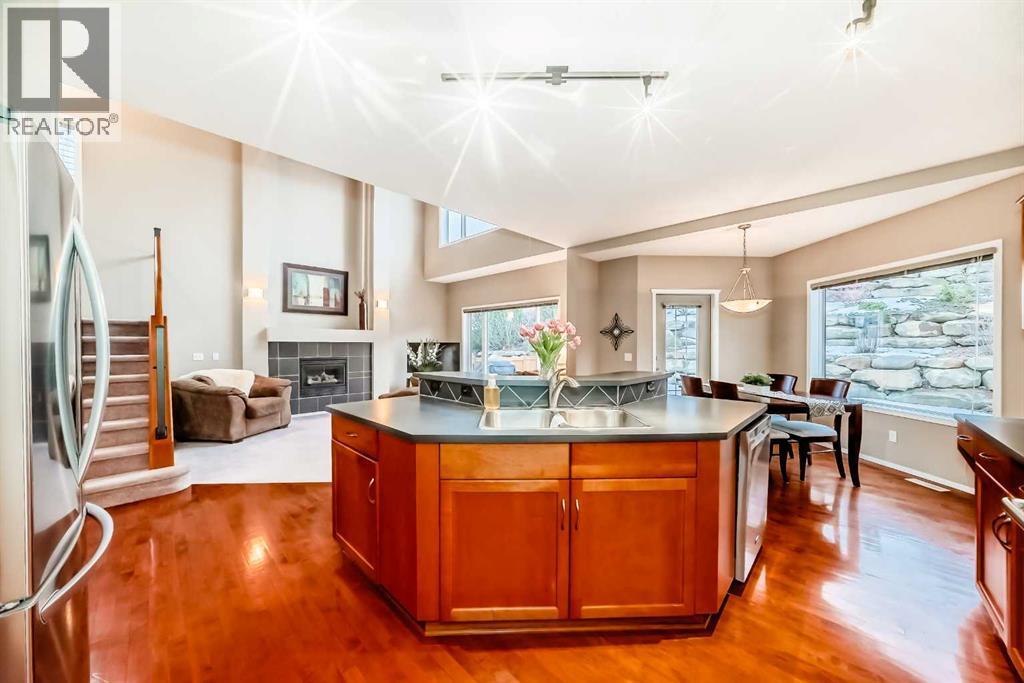 Kitchen island with eat up bar - 11931 Valley Ridge Drive Nw, Calgary, AB - Indoor Photo Showing Kitchen