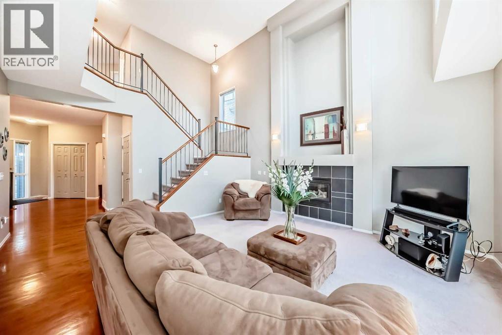 Open stairway with toms pf natural light - 11931 Valley Ridge Drive Nw, Calgary, AB - Indoor Photo Showing Living Room