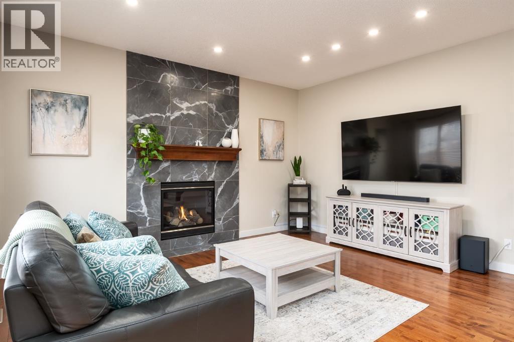 Recessed lighting - 128 Seagreen Manor, Chestermere, AB - Indoor Photo Showing Living Room With Fireplace