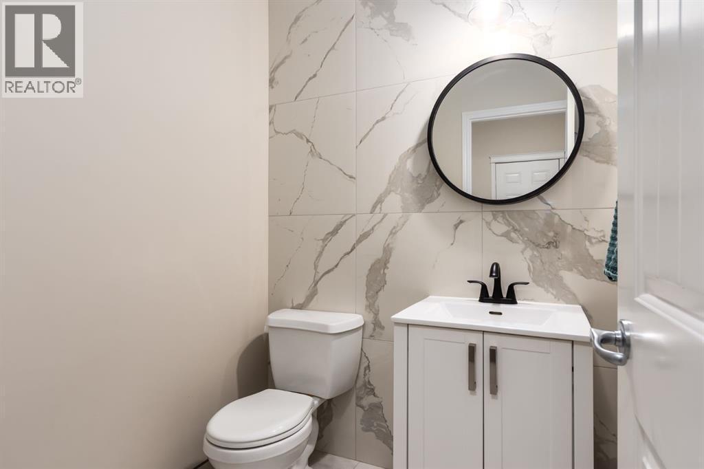 Renovated 2pc guest washroom - 128 Seagreen Manor, Chestermere, AB - Indoor Photo Showing Bathroom