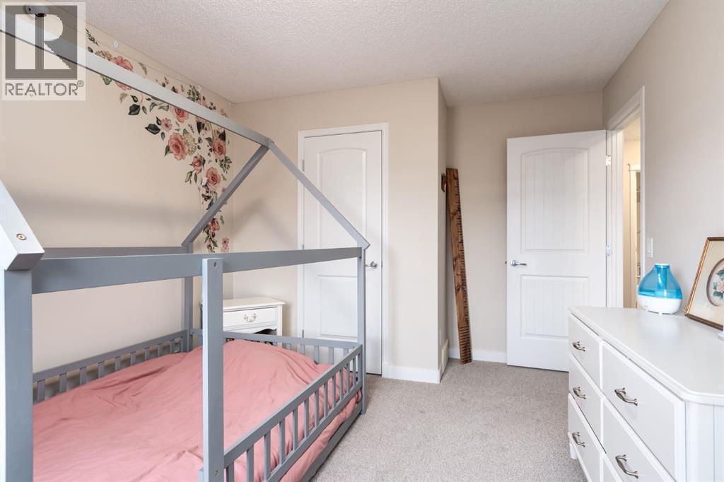 128 Seagreen Manor, Chestermere, AB - Indoor Photo Showing Bedroom
