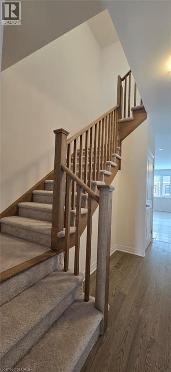 Staircase with wood finished floors and baseboards - 925 Douro Street, Stratford, ON - Indoor Photo Showing Other Room
