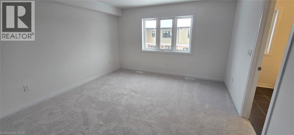Empty room with light colored carpet and baseboards - 925 Douro Street, Stratford, ON - Indoor Photo Showing Other Room