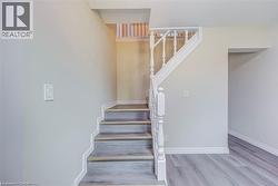 Staircase with wood finished floors and baseboards -