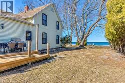 View of yard with a deck with water view -