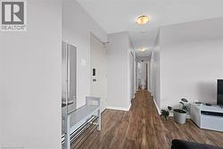 Hall with baseboards and wood finished floors -
