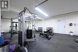 Workout area featuring baseboards and a wall mounted air conditioner -
