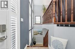 Stairs with tile patterned floors and baseboards -