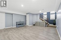 Below grade area featuring light wood-style floors and stairs -