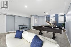 Recreation room with billiards table and wood finished floors -