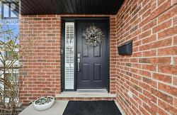 Property entrance featuring brick siding -
