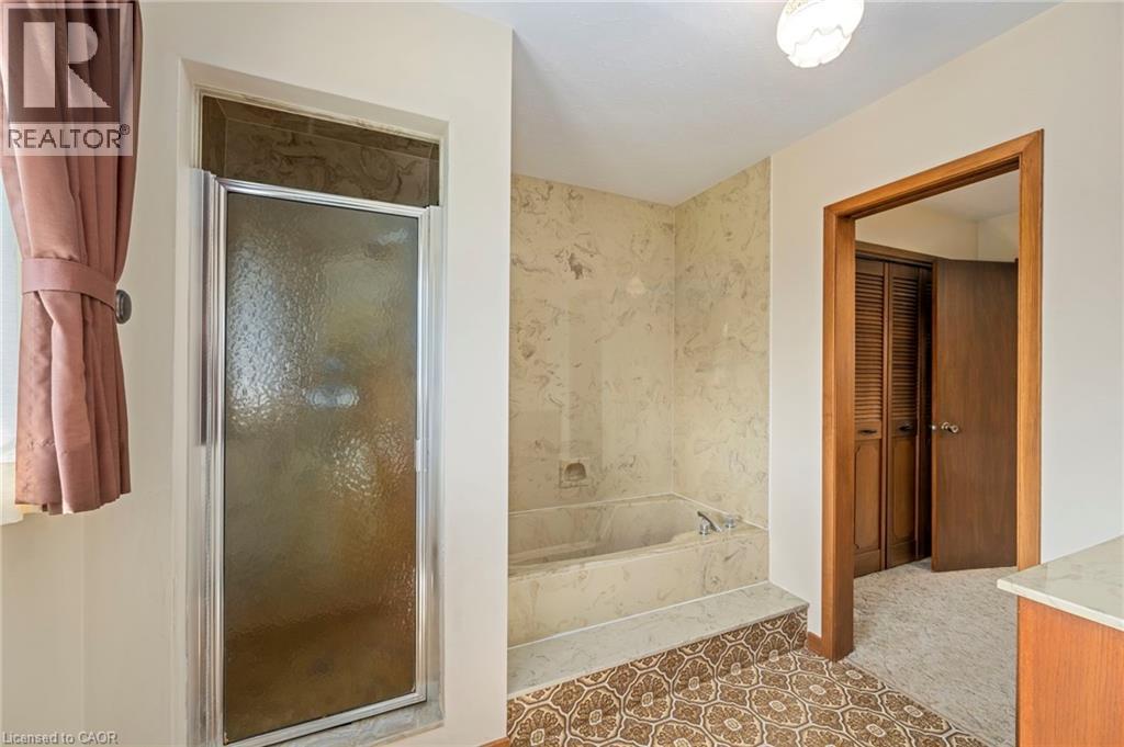 Full bath featuring a marble finish shower, vanity, and a bath - 6828 Third Line, Chatham, ON