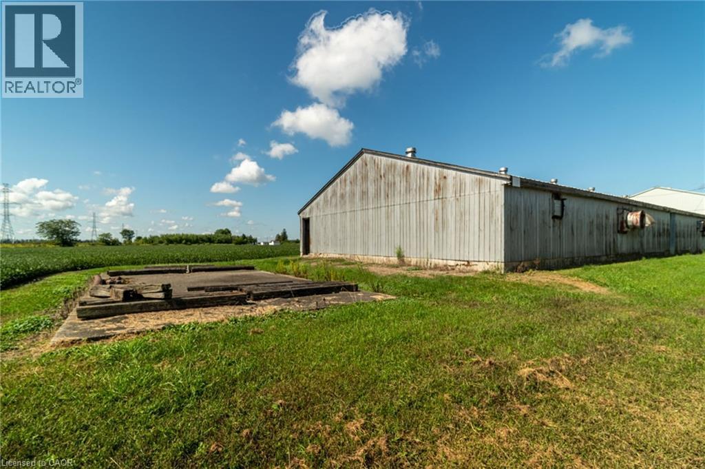 View of pole building with a lawn, a view of rural / pastoral area, and agricultural plots - 6828 Third Line, Chatham, ON
