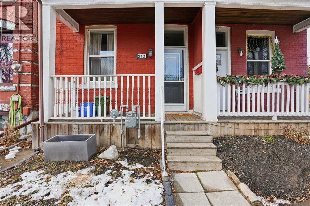 Entrance to property featuring brick siding and covered porch - 313 Mary Street, Hamilton, ON - Outdoor