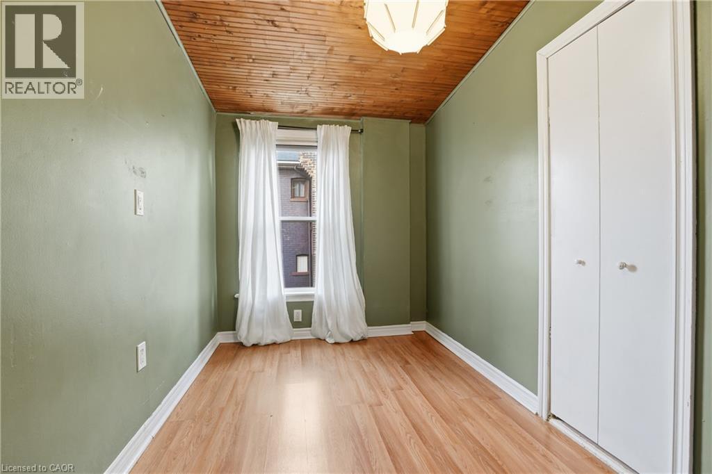 Unfurnished bedroom featuring wooden ceiling, light wood finished floors, and a closet - 313 Mary Street, Hamilton, ON - Indoor Photo Showing Other Room