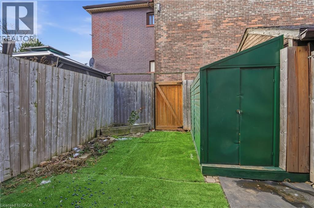 Fenced backyard with a gate - 313 Mary Street, Hamilton, ON - Outdoor With Exterior