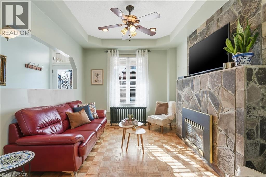 Bright sun filled living room! - 81 Simcoe Street E, Hamilton, ON - Indoor Photo Showing Living Room With Fireplace