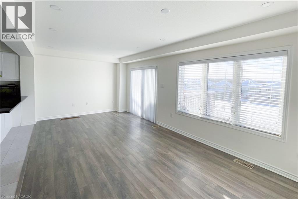Unfurnished living room with light wood-style flooring and recessed lighting - 116 Watermill Street, Kitchener, ON - Indoor Photo Showing Other Room