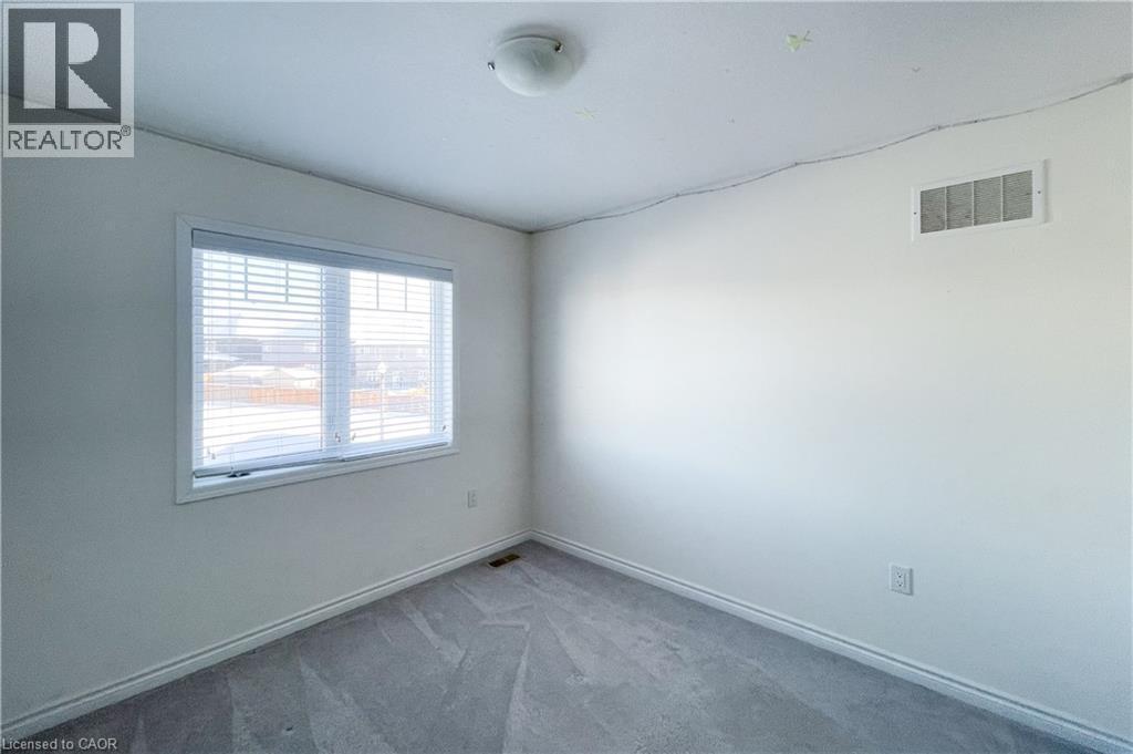 Empty room featuring carpet floors and baseboards - 116 Watermill Street, Kitchener, ON - Indoor Photo Showing Other Room