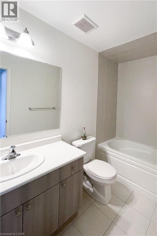 Full bathroom featuring vanity, light tile patterned floors, and shower / washtub combination - 116 Watermill Street, Kitchener, ON - Indoor Photo Showing Bathroom