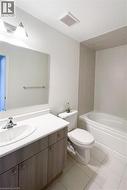 Full bathroom featuring vanity, light tile patterned floors, and shower / washtub combination -