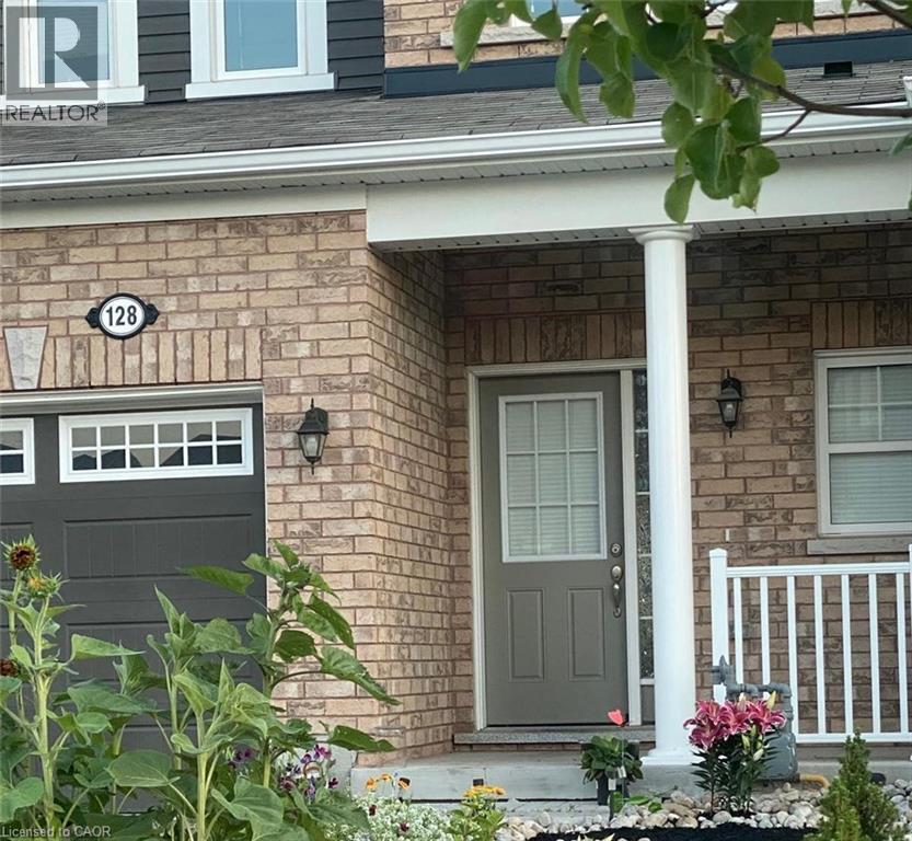 View of exterior entry featuring a porch, a shingled roof, and stone siding - 128 Watermill Street, Kitchener, ON - Outdoor
