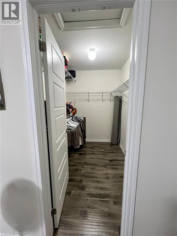 Spacious closet featuring cooling unit and dark wood finished floors - 128 Watermill Street, Kitchener, ON - Indoor