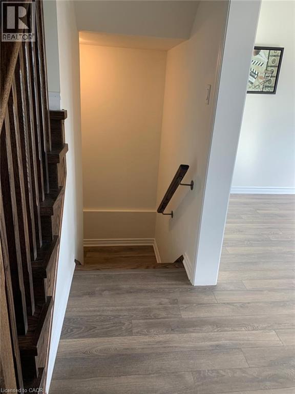 Stairs with wood finished floors - 128 Watermill Street, Kitchener, ON - Indoor Photo Showing Other Room