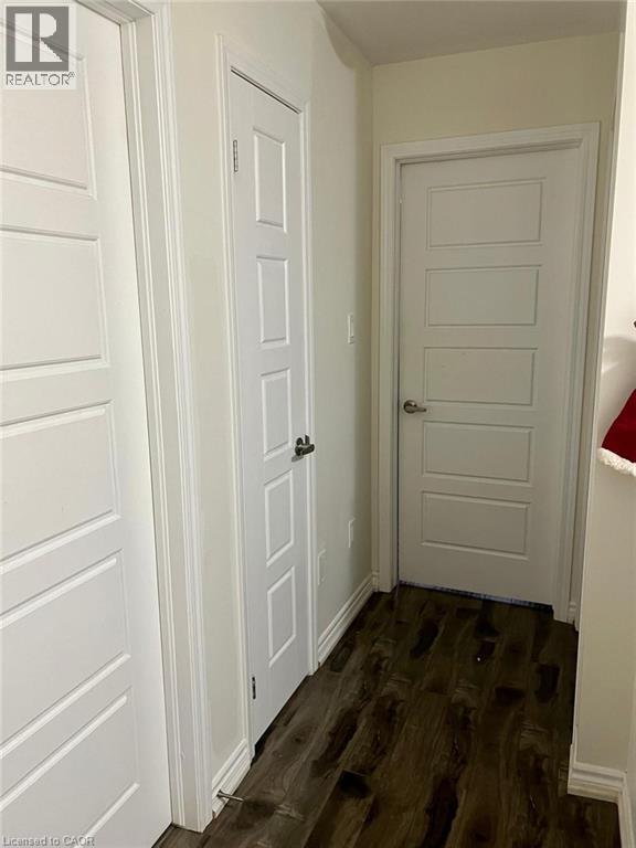 Hallway featuring dark wood-type flooring and baseboards - 128 Watermill Street, Kitchener, ON - Indoor Photo Showing Other Room