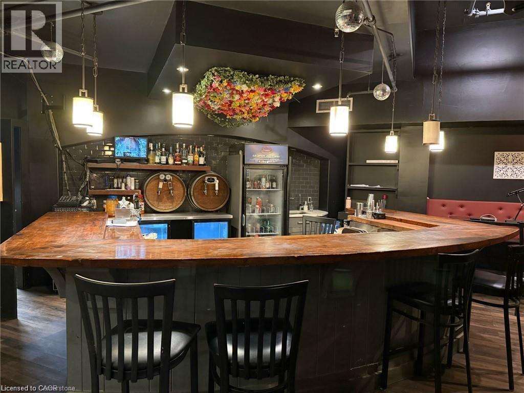 Indoor wet bar with pendant lighting, wood counters, and open shelves - 179 King Street W, Kitchener, ON