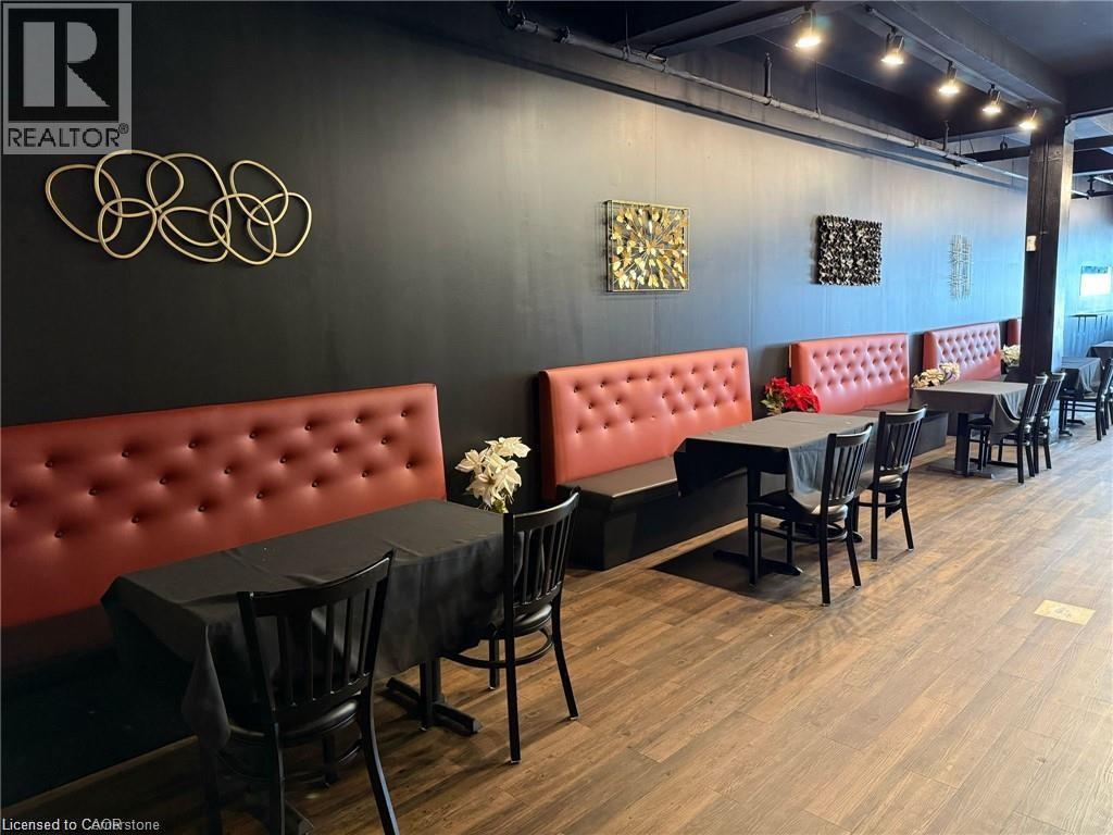 Dining area featuring wood finished floors and track lighting - 179 King Street W, Kitchener, ON