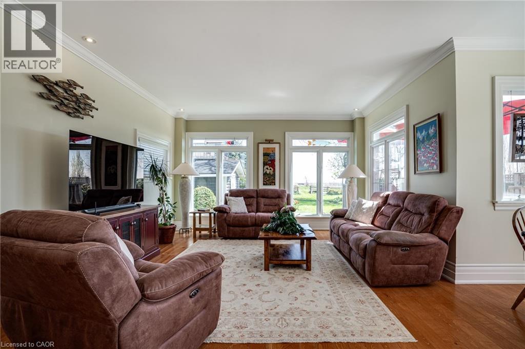 Living area with crown molding, wood finished floors, and healthy amount of natural light - 849 Beach Boulevard, Hamilton, ON - Indoor Photo Showing Living Room