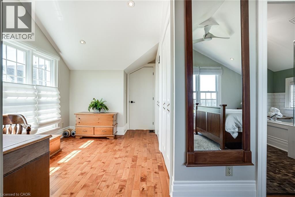 Bedroom featuring vaulted ceiling, light wood-style floors, multiple windows, and recessed lighting - 849 Beach Boulevard, Hamilton, ON - Indoor