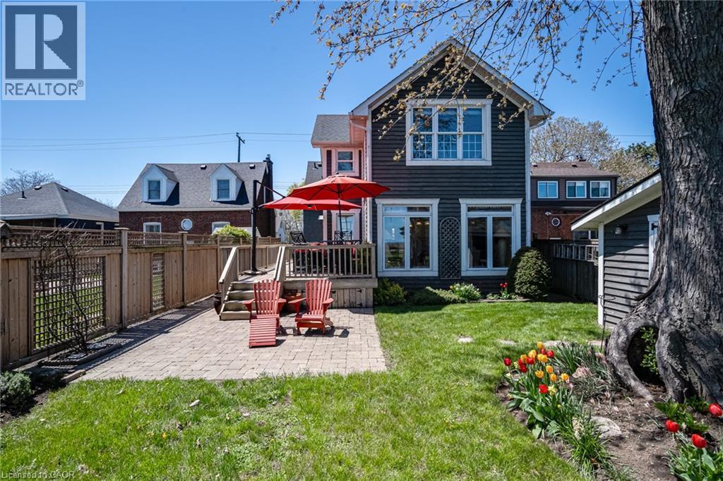 Back of property with a fenced backyard, a patio, and a wooden deck - 849 Beach Boulevard, Hamilton, ON - Outdoor With Deck Patio Veranda