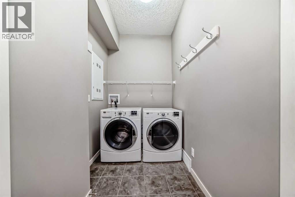 238 Panatella Nw, Calgary, AB - Indoor Photo Showing Laundry Room
