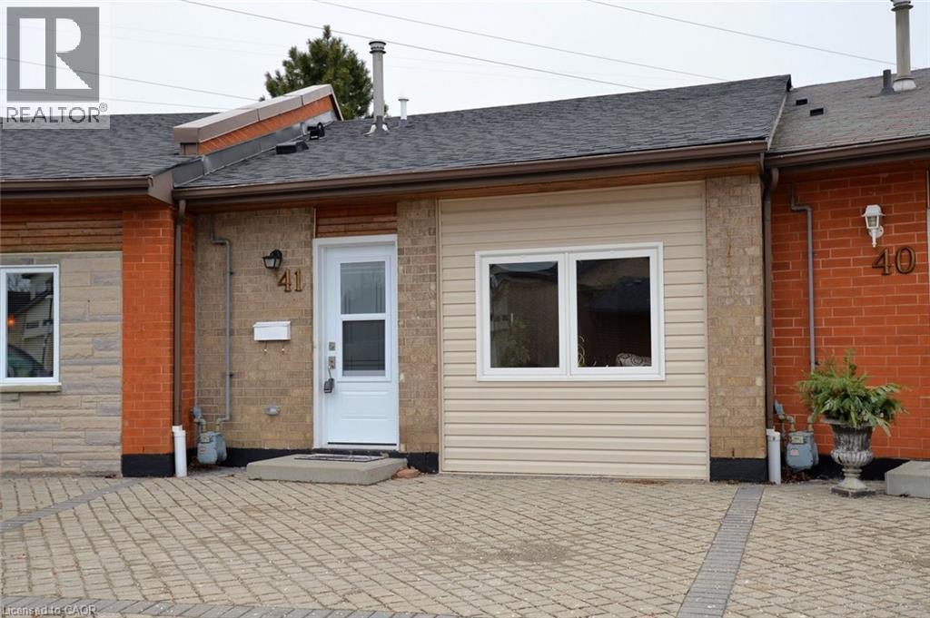 Back of property featuring roof with shingles, brick siding, and a patio - 41 Sister Kern Terrace, Hamilton, ON - Outdoor With Exterior