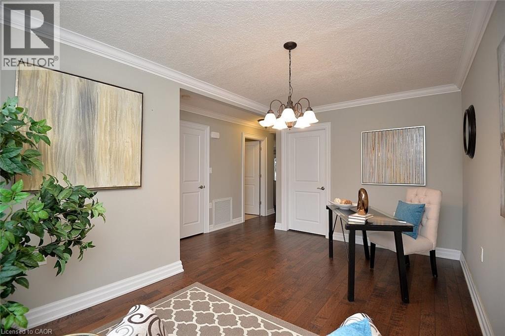 Home office with crown molding, a textured ceiling, dark wood finished floors, and a chandelier - 41 Sister Kern Terrace, Hamilton, ON - Indoor