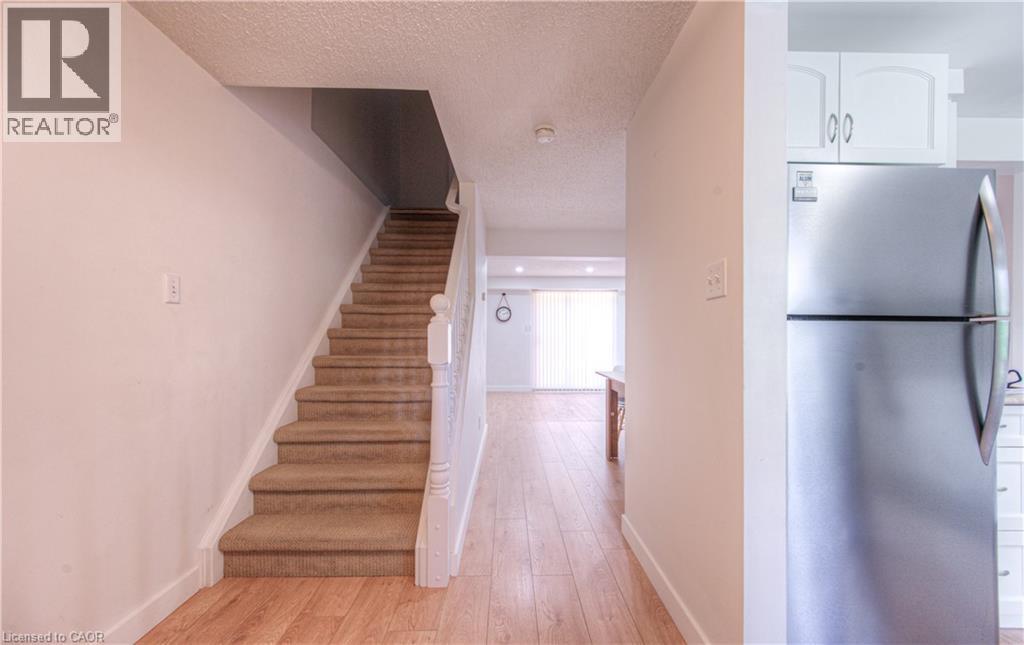 Stairs with hardwood / wood-style flooring and a textured ceiling - 236 Bankside Drive, Kitchener, ON - Indoor Photo Showing Other Room