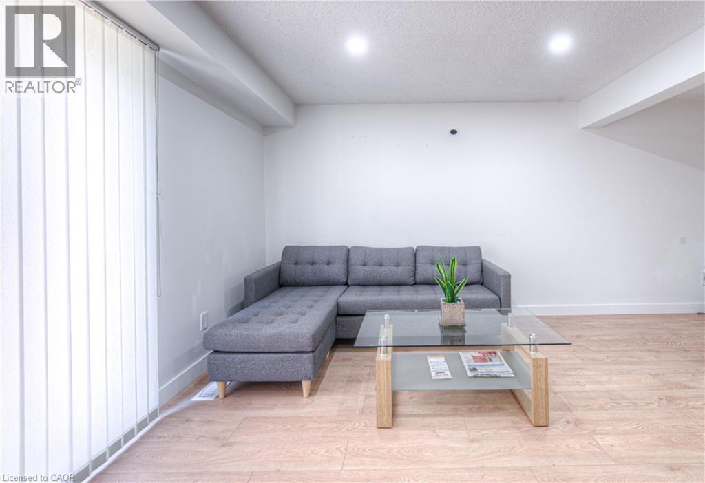 Living area with wood finished floors, recessed lighting, a textured ceiling, and lofted ceiling - 236 Bankside Drive, Kitchener, ON - Indoor