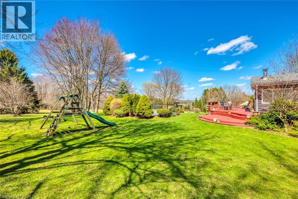 View of yard featuring a deck and playground community - 1215 Britannia Road, Burlington, ON