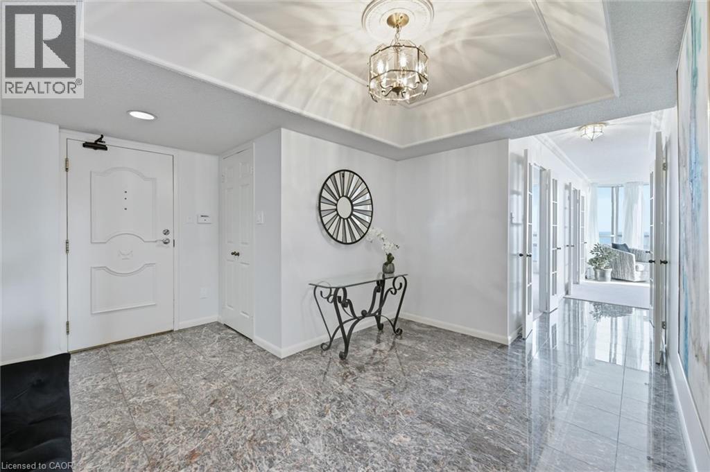 Entryway featuring baseboards and a chandelier - 2170 Marine Drive Unit# 1808, Oakville, ON - Indoor Photo Showing Other Room