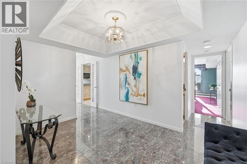 Hallway featuring a chandelier and granite floors - 2170 Marine Drive Unit# 1808, Oakville, ON - Indoor Photo Showing Other Room