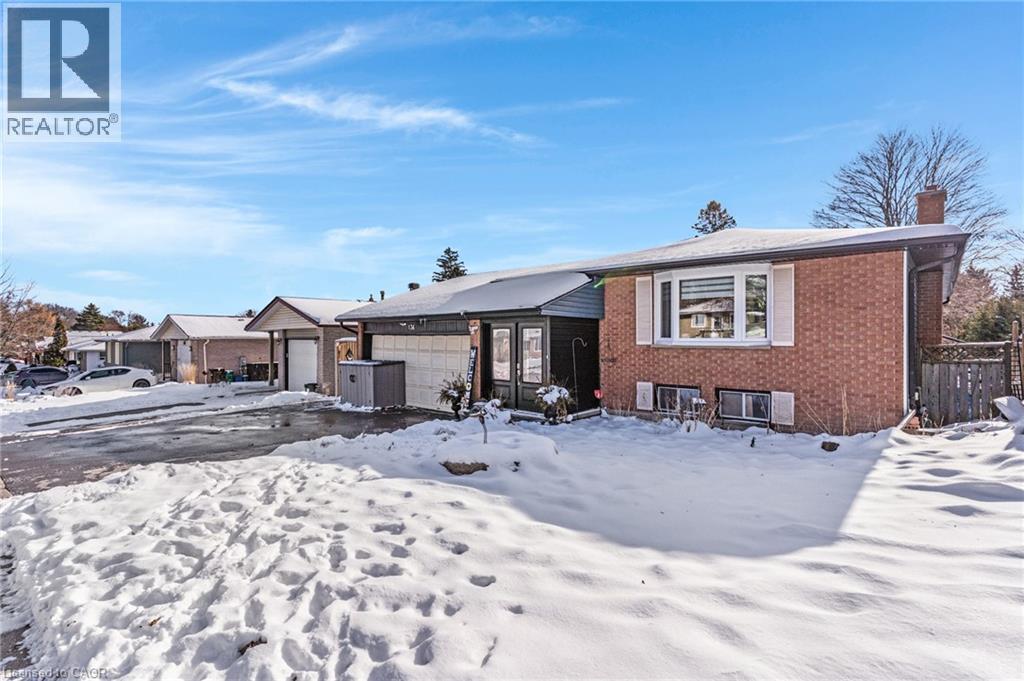 Raised Bungalow featuring brick siding, a chimney, and a garage - 136 Limpert Avenue, Cambridge, ON - Outdoor